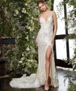 Model wearing JB03592 beige gown with floral appliqués and a high slit, front view.