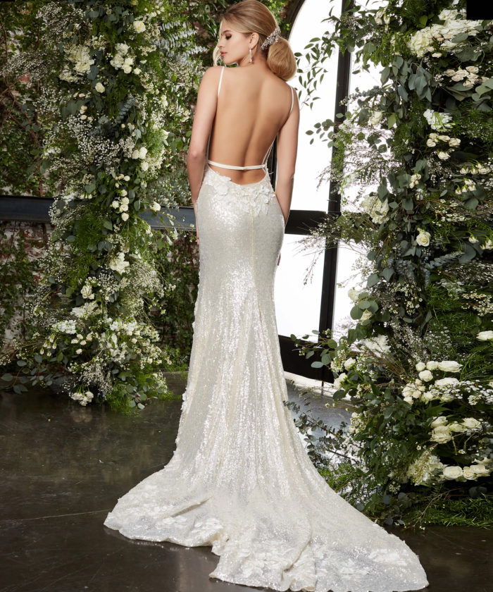 Model wearing JB03592 beige gown with an open back.