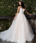 Model wearing Jovani JB05353 white gown with V-neckline and lace appliques