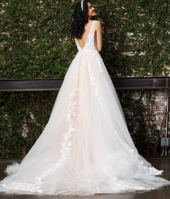 Model wearing Jovani JB05353 white gown, back view with open V-back