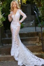 Model wearing Jovani JB06861 ivory gown with floral lace and sheer long sleeves.