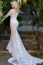 Back view of model wearing Jovani JB06861 ivory gown with lace details.