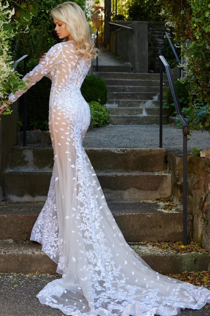 Back view of model wearing Jovani JB06861 ivory gown with lace details.