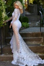 Model showcasing the back of Jovani JB06861 ivory gown with floral lace.