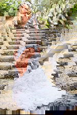 Model wearing Jovani JB07059 elegant gown with lace detailing and dramatic train, front view.