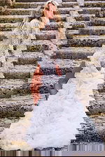 Model wearing Jovani JB07059 elegant gown with lace detailing and dramatic train, back view.