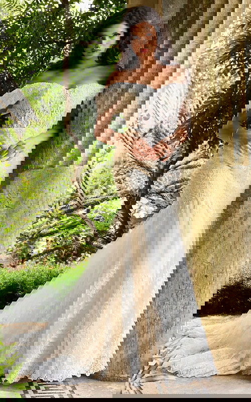 Model wearing Jovani JB07161 ivory dress with off-the-shoulder sleeves