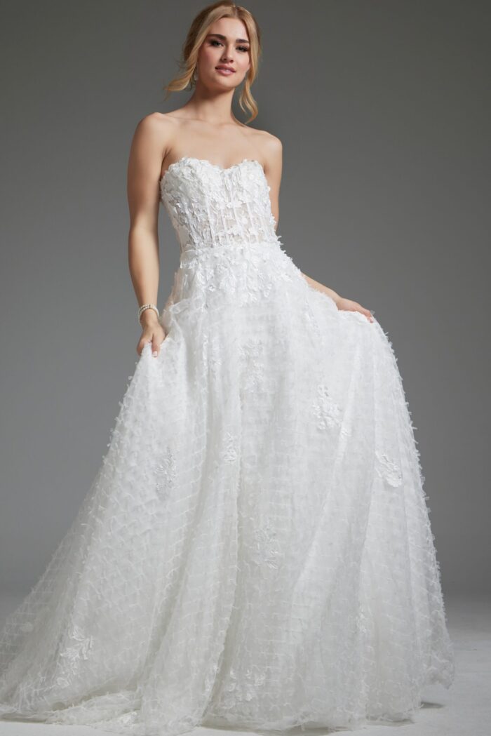 Model wearing Jovani JB07165 white gown showing A-line silhouette and floral appliqué, full front view.