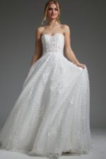 Model wearing Jovani JB07165 white gown with intricate floral patterns, front view.