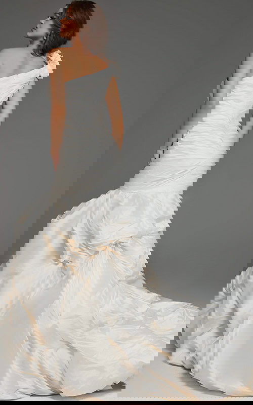 Model wearing Jovani 07179 white gown with one-shoulder neckline and mermaid silhouette, back view.