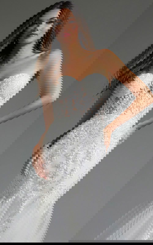 Close-up of model in Jovani JB07260 gown, showing strapless neckline and floral embroidery.