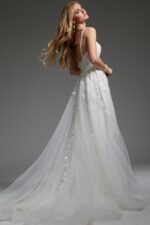 Model showcasing the back of Jovani JB07311 ivory dress with open back design.