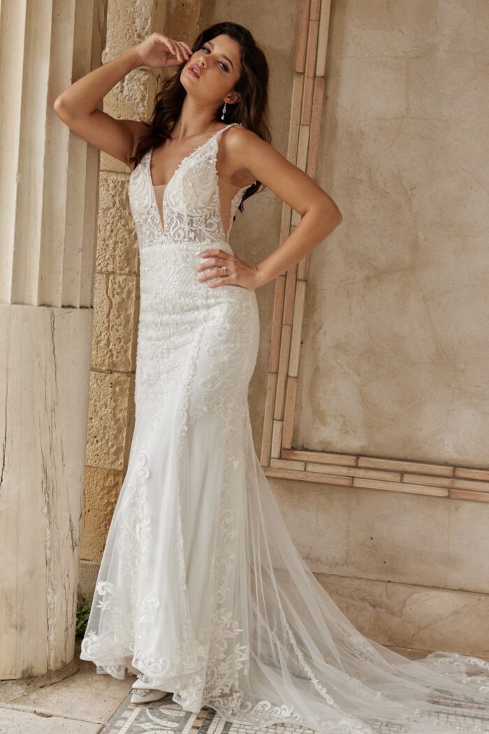 Model wearing Jovani JB07385 ivory dress with V-neckline and lace detailing.