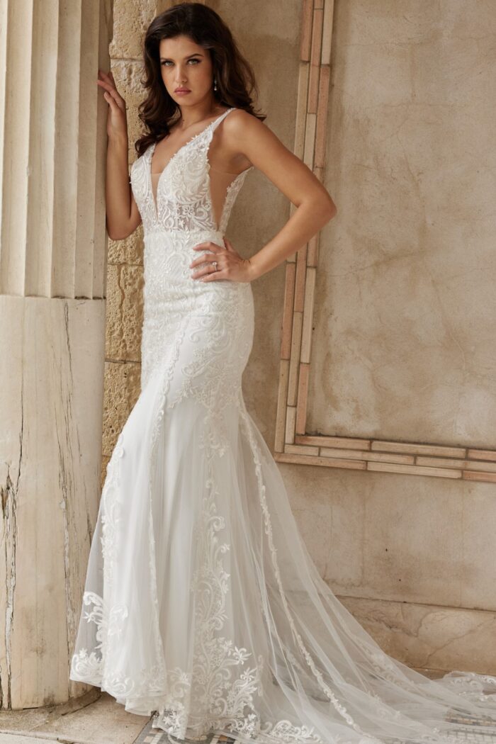 Model in Jovani JB07385 ivory gown, showcasing lace design and mermaid silhouette.