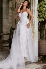 Model wearing Jovani JB07452 white gown with floral details, side view.