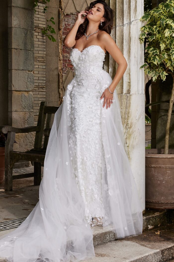 Model wearing Jovani JB07452 white gown with floral details, side view.
