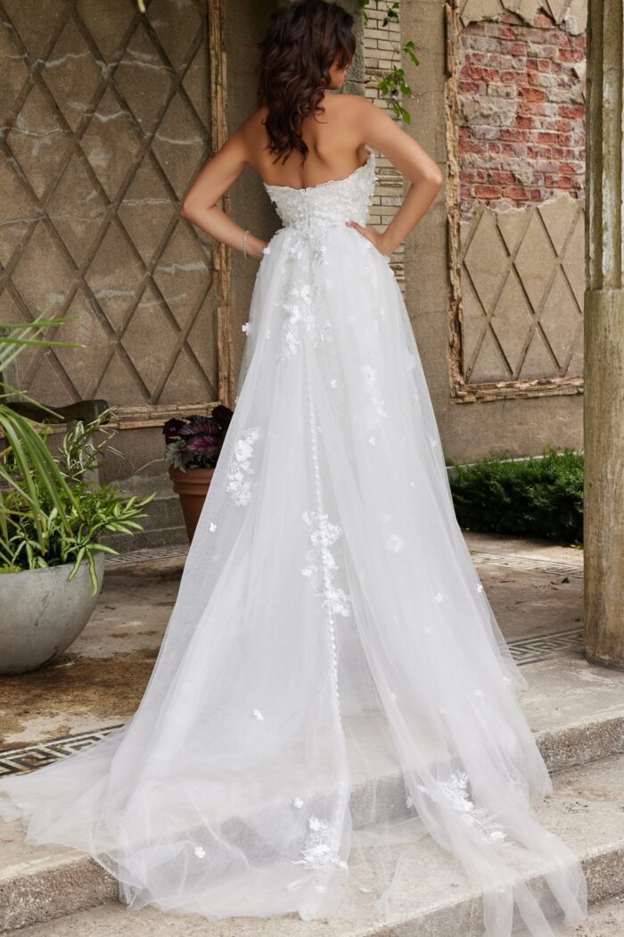 Back view of Jovani JB07452 white gown with elegant trailing overlay.