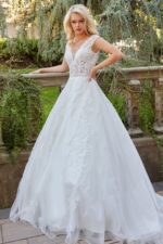 Model wearing Jovani JB07633 dress with A-line silhouette and V-neckline in ivory, front view.