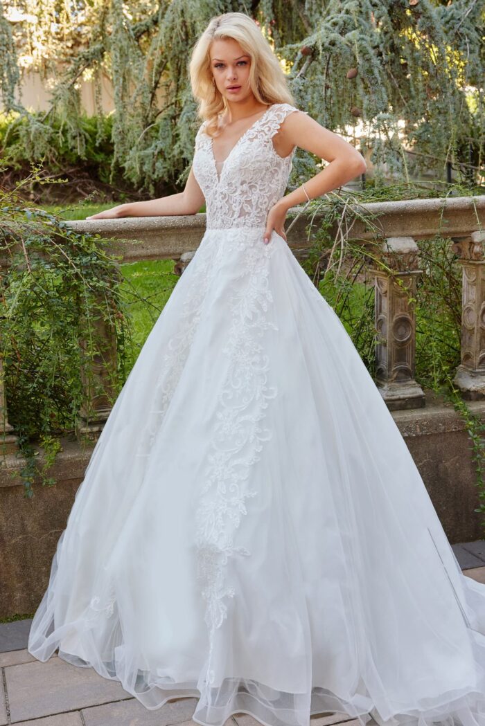 Model wearing Jovani JB07633 dress with A-line silhouette and V-neckline in ivory, front view.