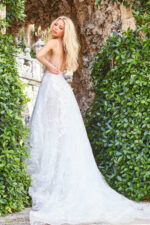 Back view of model in Jovani JB07646 ivory gown with open back design