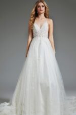 Model in Jovani JB07647 ivory gown, showcasing V-neckline and lace bodice.