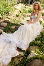 Model seated in JB24145 white lace gown with dramatic train