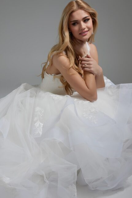 Model seated in Jovani JB41002 dress with layered skirt details