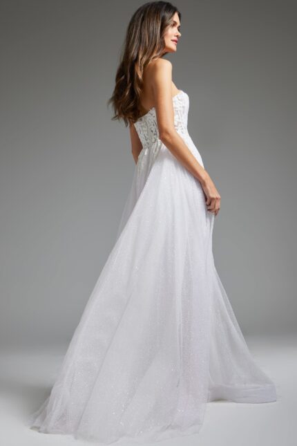 model wearing Jovani JB24560 white gown, back view revealing cascading fabric