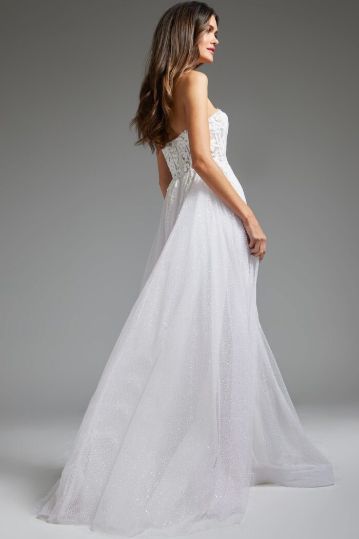 model wearing Jovani JB24560 white gown, back view revealing cascading fabric