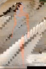 Strapless lace gown with illusion bodice, high slit, and soft tulle skirt.