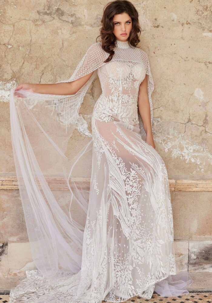 Model wearing JB36547 elegant white dress with mesh overlay and floral lace detailing.
