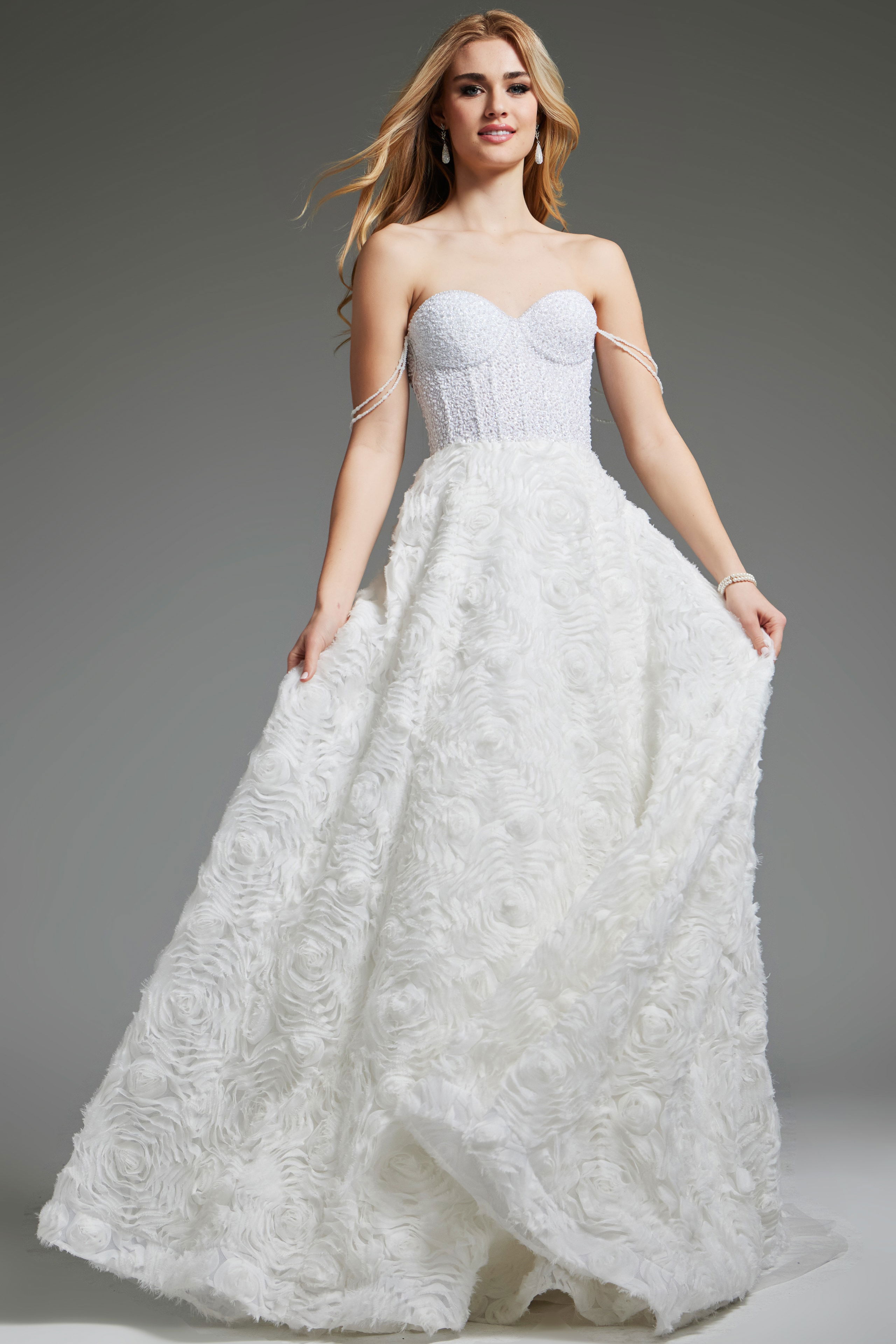 JB36644-OFFWHITE-2010.jpg Model wearing Jovani JB36644 white ball gown with rosette pattern and sweetheart neckline.