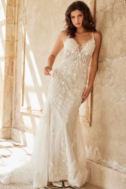 Model wearing Jovani JB37532 ivory gown with detailed lace V-neckline from the front view.