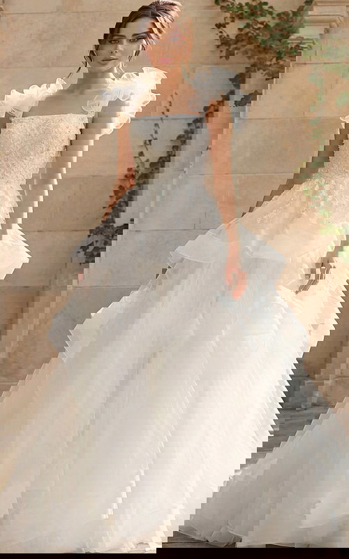 Elegant ball gown wedding dress with tiered tulle skirt and ruffled shoulder straps