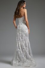 Model wearing Jovani JB38221 back view highlighting the covered buttons and detailed lacework of the ivory dress.