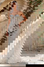 Strapless lace mermaid gown with floral pattern, sweetheart neckline, and fitted silhouette with a soft train.