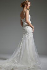 Model showcasing JB38479 off-white dress with a flattering scoop back and trumpet silhouette, back view.