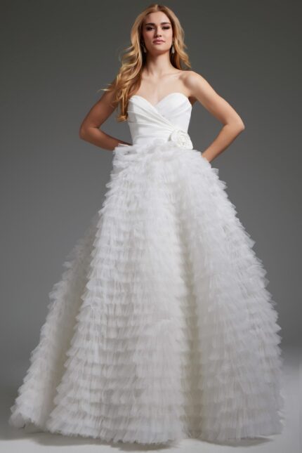 Model wearing Jovani JB38958 white gown with sweetheart neckline and ruffled skirt.