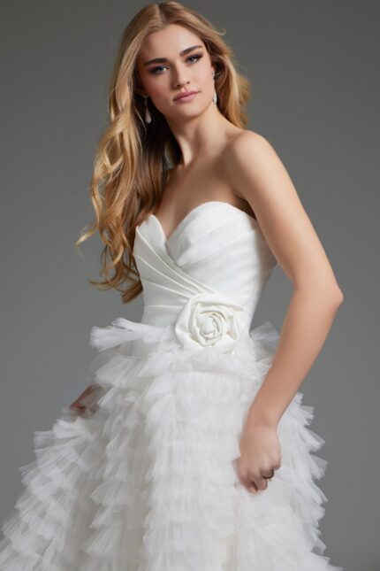 Side view of model in Jovani JB38958 white gown with tiered skirt.