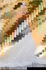 Strapless floral lace wedding gown with sheer bodice and flowing tulle skirt