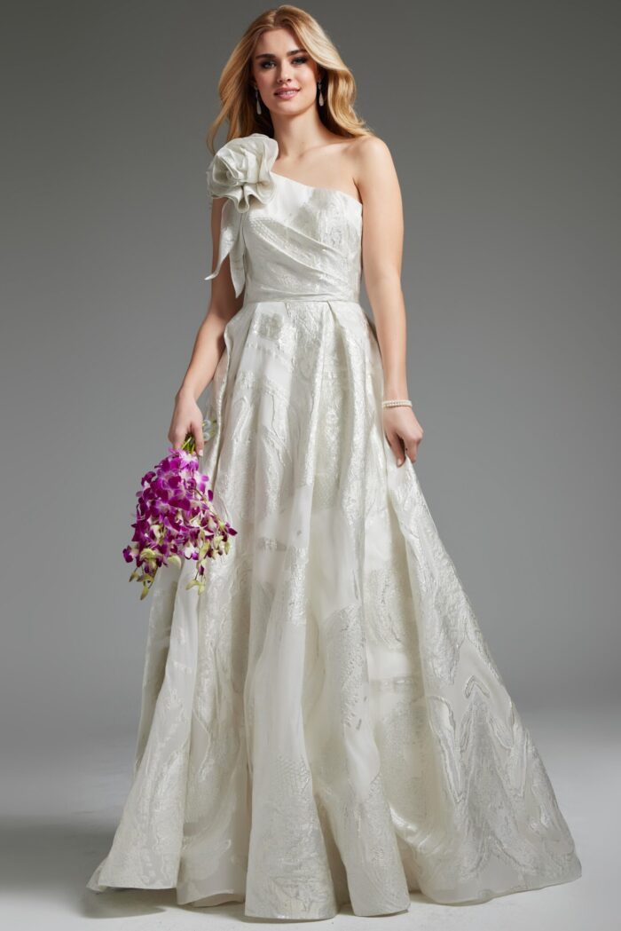 Model wearing Jovani JB39218 elegant white dress with floral shoulder detail, front view.