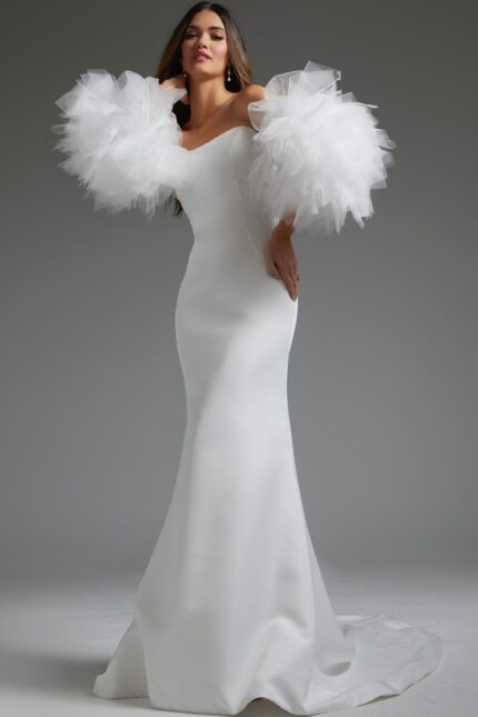 Model wearing Jovani JB40601, a white mermaid gown with voluminous tulle sleeves.