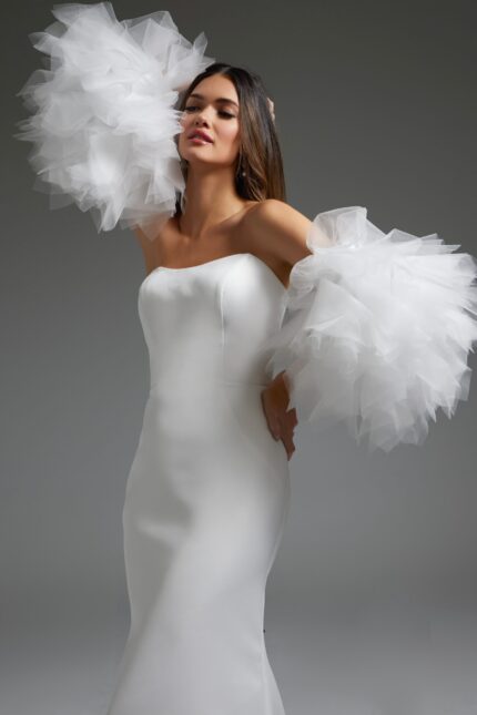 Model wearing Jovani JB40601 white gown, showcasing off-the-shoulder tulle sleeves.