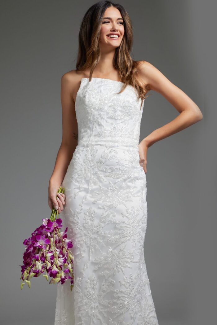 Model wearing JB40608 refined white gown holding flowers, showcasing the elegant lace design