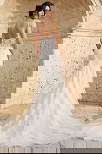 Back view of beaded mermaid wedding dress with floral appliques and sheer straps