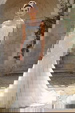 Mermaid bridal gown with floral beading, sheer bodice, and flowing tulle train