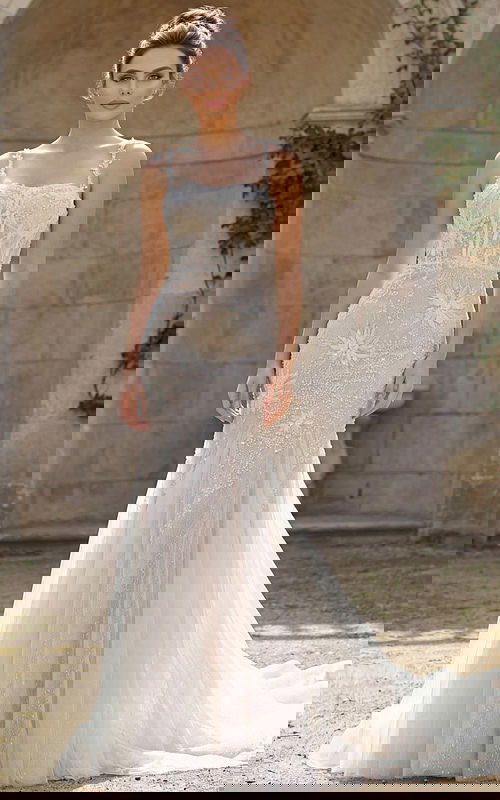 Mermaid bridal gown with floral beading, sheer bodice, and flowing tulle train