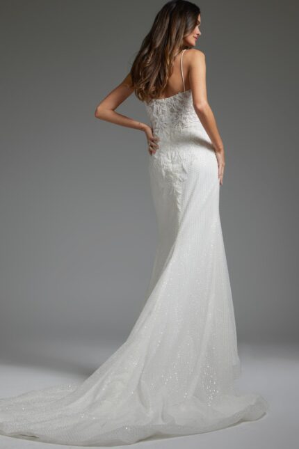 Model showcasing the back of Jovani JB40639, an ivory gown with lace details and a subtle flair.