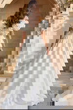 Off shoulder ball gown with oversized floral sleeves and button back detail.