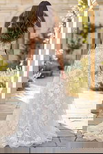 Back view of strapless lace wedding gown with floral embroidery and flowing train